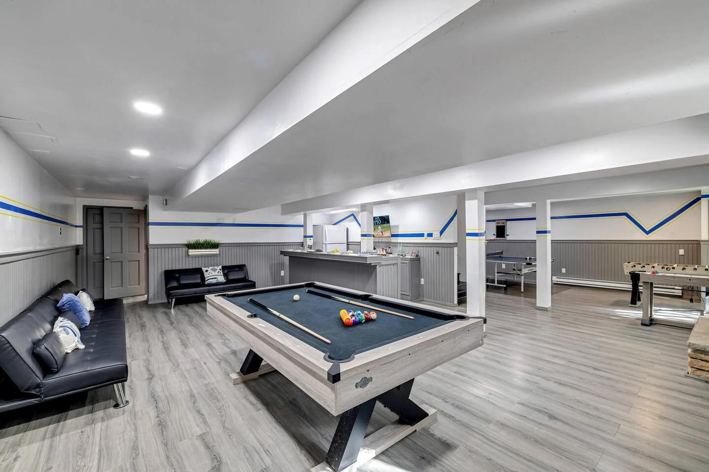 Game room with pool table and shuffleboard at The Ultimate Pocono Escape vacation rental in Tobyhanna